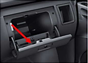 Arrow pointing to inside cover of glove compartment hatch identifying location of the tire placard
